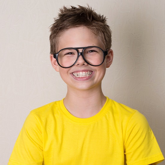 Smiling preteen with an orthodontic appliance