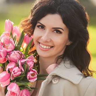 Smiling woman with clear and ceramic braces