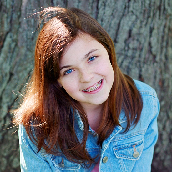 Smiling young woman receiving dentofacial orthopedics treatment