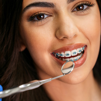 a patient with braces smiling 