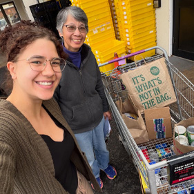 2 women smiling at Milton Orthodontics food drive