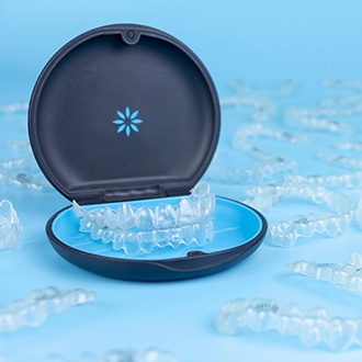 Several Invisalign trays lying on blue background