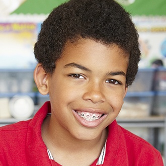 Young boy with pediatric orthodontics smiling