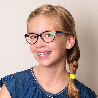 Preteen with traditional braces smiling