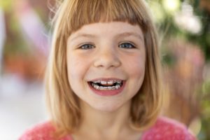 Young girl with pediatric braces in Milton smiles