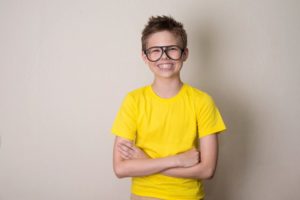 Smiling boy with braces or pediatric orthodontics in Milton