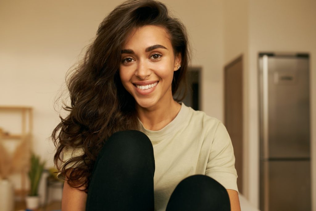 Closeup of woman with straight teeth smiling