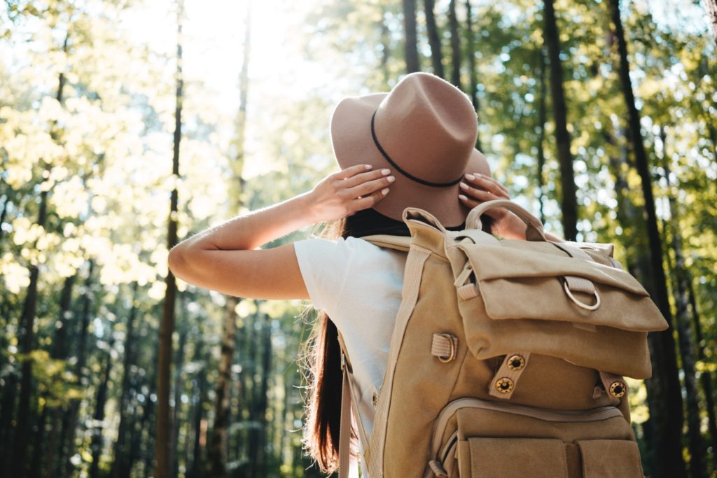 Closeup of woman backpacking through scenic forest