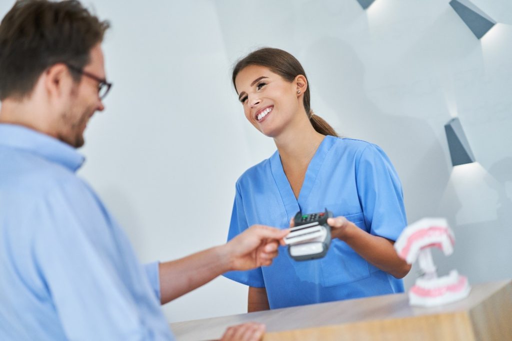 Man paying for orthodontic treatment