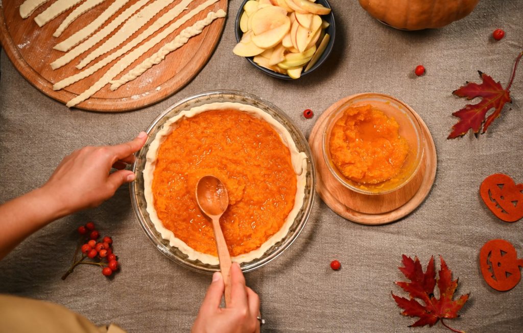 Closeup of person making pumpkin pie