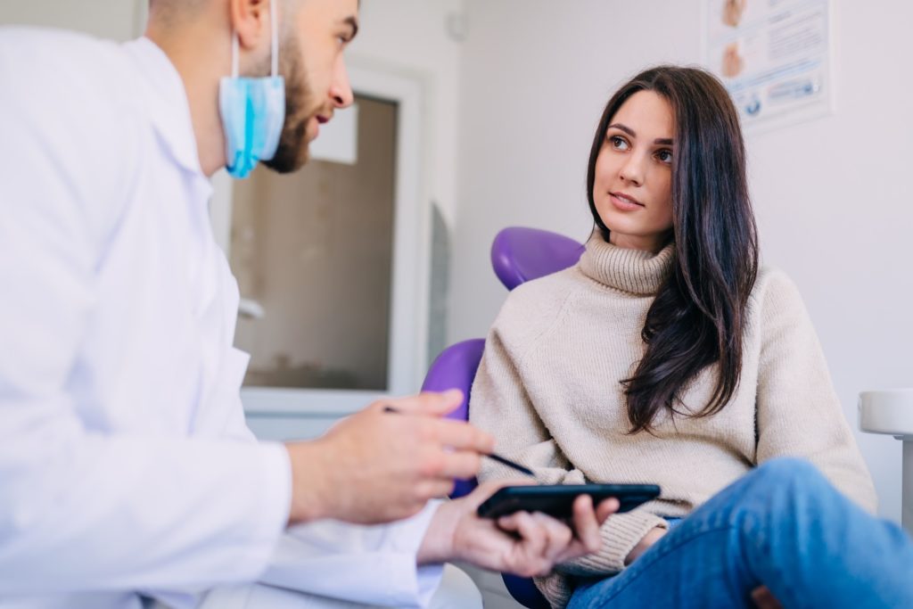 Orthodontist explaining dental insurance information to patient