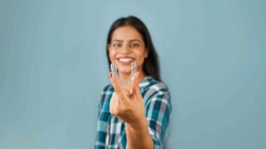 a person holding their Invisalign aligner